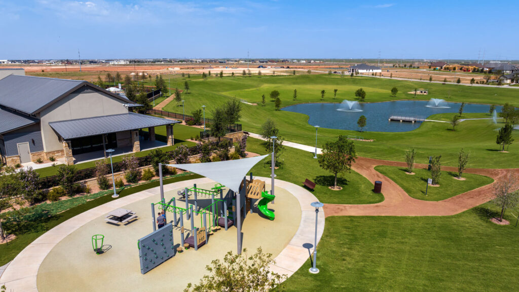Vineyard amenity center with pool and playground visible against backdrop of community trail system