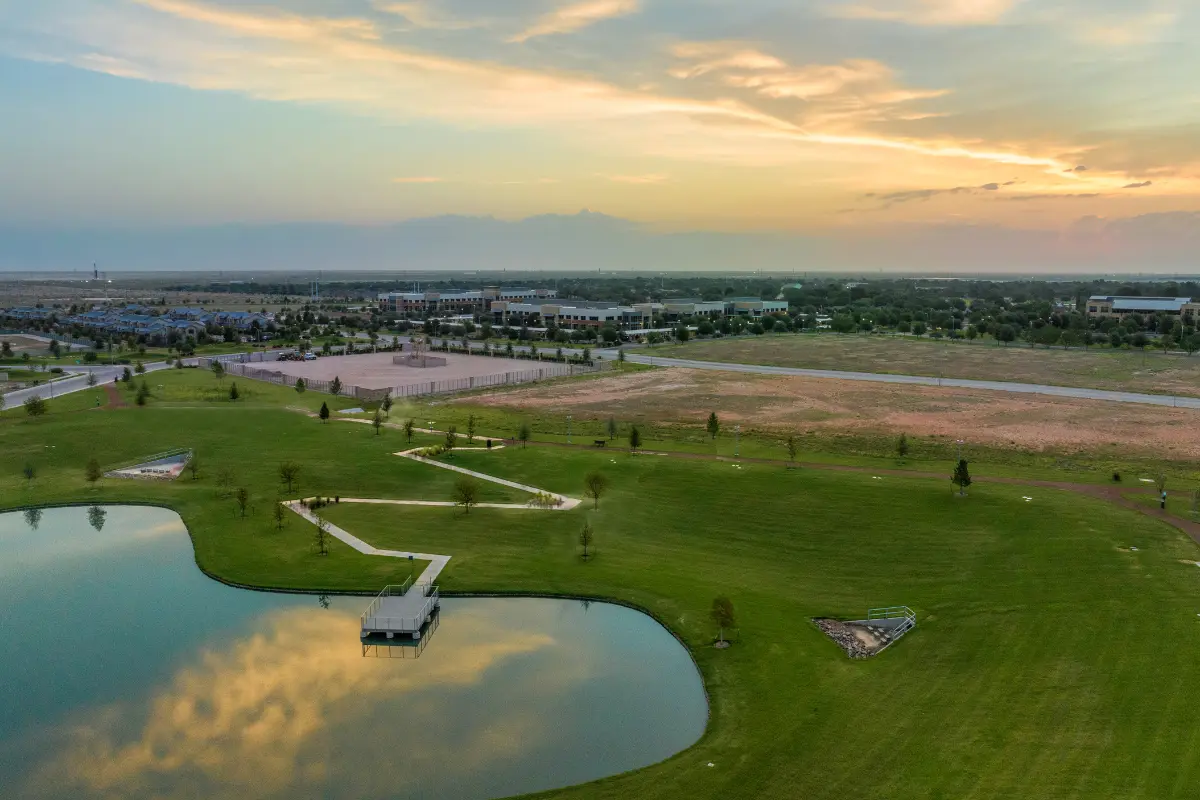 Aerial view of The Vineyard Preserve community featuring a lake and walking path.